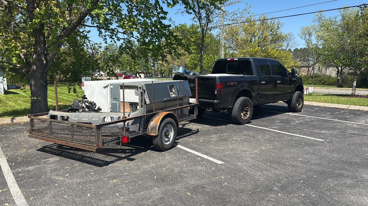 Trash Titans truck and trailer loaded on a job